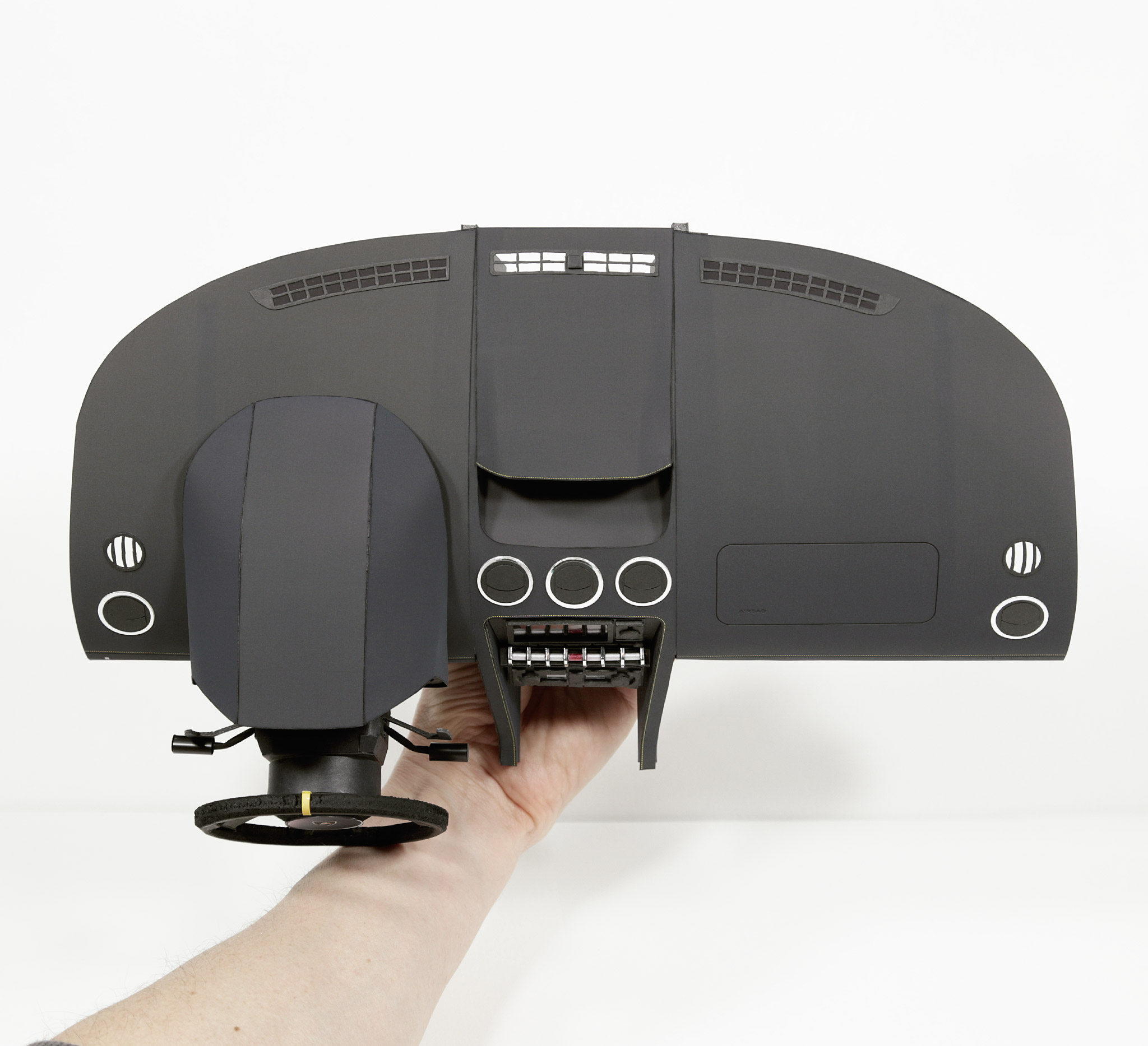 Top view of the finished dashboard; instrument cluster; infotainment; and steering column assembly.